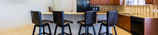 Rapallo Apartments community clubhouse kitchen area equipped with refrigerator, microwave, and dishwasher.