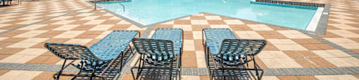 Pool area with view of the exterior building at Rapallo Apartments in Kissimmee, Florida