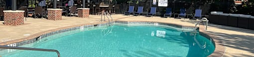 A small pool with a metal fence around it.
