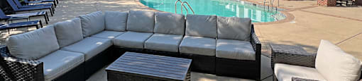 A large outdoor patio area with a pool and furniture.