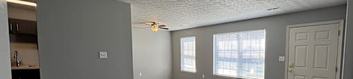 A room with grey walls and wooden flooring.