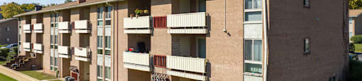 Apartment building with a green lawn in front.