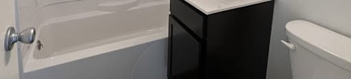 A white toilet sits next to a sink in a bathroom.