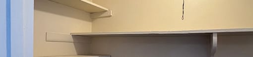 Empty white shelves in a room.