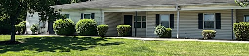 A spacious lawn and single-story apartment.