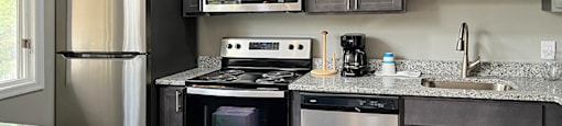 a kitchen with stainless steel appliances and granite countertops