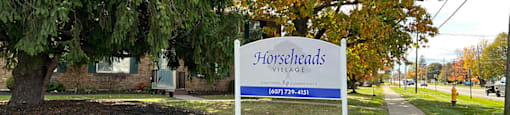A sign for Horsesheads with a phone number on it.