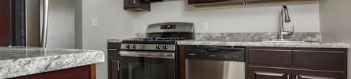 a kitchen with stainless steel appliances and marble counter tops