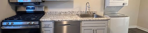 A kitchen with a stove, oven, microwave, and dishwasher.
