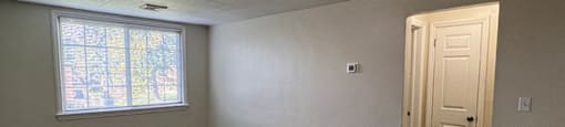 A room with a door and a window.