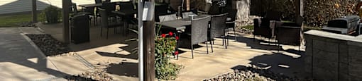 A covered patio area with a table and chairs.