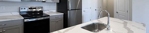 a kitchen with a marble counter top and a sink