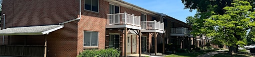 A brick building with a green lawn in front.