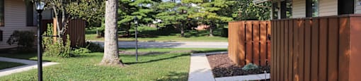 A shady sidewalk at Sunset Ridge Apartments.