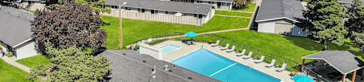 an aerial view of a house with a swimming pool at Cadence Apartments, Roy Utah