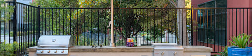 utside Grills With a Large Umbrella, Seating, and Tables at FREMONT MEWS, California, 95814