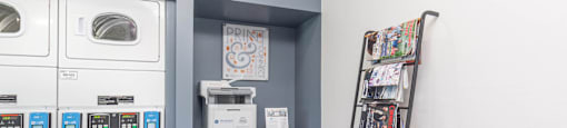 a laundry room with washer and dryer and a ladder at Cadence Apartments, Roy, UT