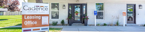 a building with a leasing office and a sign in front of it at Cadence Apartments, Roy, 84103