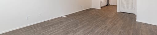 a living room and kitchen with wood flooring and white walls at Cadence Apartments, Utah