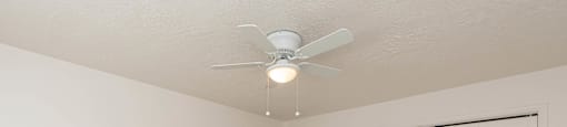 a bedroom with a ceiling fan and a closet at Cadence Apartments, Roy, UT 84067