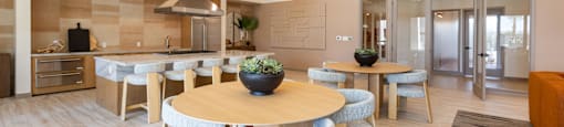 A modern dining area with a round table and chairs.