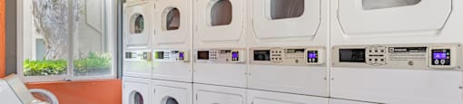 A row of washing machines in a laundromat.