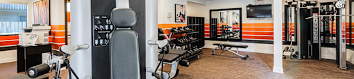 a gym with various machines and chairs in a room at CASA GRANDE APARTMENT HOMES, Cypress, CA, 90630
