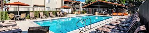 our apartments have a pool and lounge chairs at CASA GRANDE APARTMENT HOMES, Cypress, CA, 90630