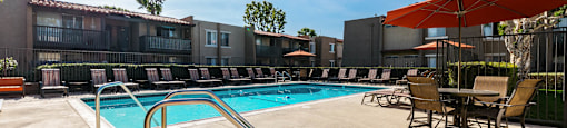our apartments have a resort style pool with chairs and umbrellas at CASA GRANDE APARTMENT HOMES, Cypress, 90630