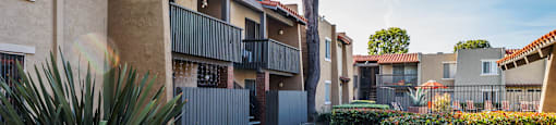 a walkway between two apartment buildings with a sidewalk at CASA GRANDE APARTMENT HOMES, Cypress