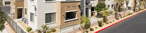 a row of apartment buildings with a street in front of them at CHANDLER APARTMENT HOMES, Las Vegas