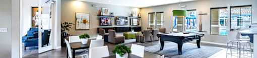 a living room with a table and chairs and a pool at CHANDLER APARTMENT HOMES, Las Vegas, 89139