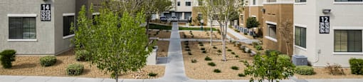 a view of a courtyard between several apartment buildings at CHANDLER APARTMENT HOMES, Las Vegas, NV