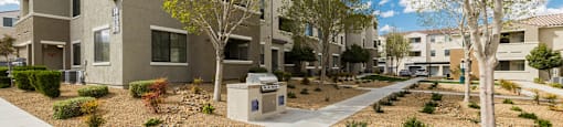 an exterior view of an apartment complex with trees and a sidewalk at CHANDLER APARTMENT HOMES, Las Vegas, NV, 89139