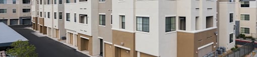 a row of apartment buildings with a street in front of them at CHANDLER APARTMENT HOMES, Las Vegas, 89139