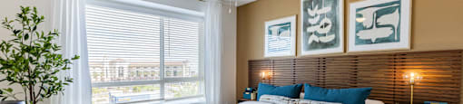 A bedroom with a large bed and a ceiling fan.
