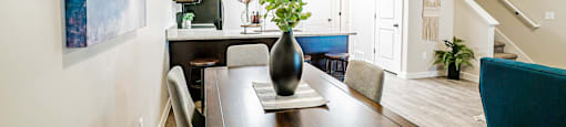 a dining room with a table and chairs at Arcadia Townhomes, Roy Utah