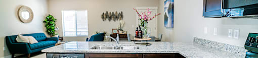 a kitchen with a counter top and a sink at Arcadia Townhomes, Roy Utah