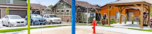 a red fire hydrant sitting under a yellow and blue umbrella at Arcadia Townhomes, Utah