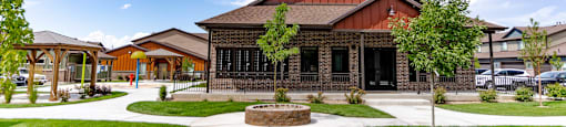 the front of a house with a yard and a sidewalk at Arcadia Townhomes, Roy, UT