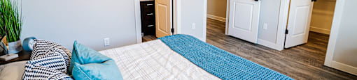 a bedroom with a large bed and a closet at Arcadia Townhomes, Roy, UT