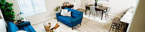 an aerial view of a living room and dining room with blue furniture at Arcadia Townhomes, Roy, UT 84067