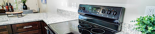a kitchen with a stove and a microwave at Arcadia Townhomes, Roy, 84067