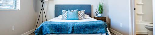 a bedroom with a bed and a closet at Arcadia Townhomes, Roy, UT