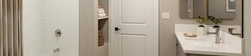 A bathroom with a white door and a white sink.