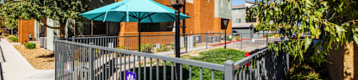 A building with a blue umbrella in front of it.
