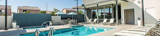 Pool with lounge chairs at THE RISE APARTMENT HOMES, Las Vegas, 89139
