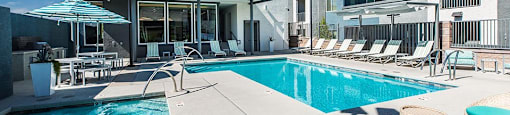 Pool and spa with lounge chairs at THE RISE APARTMENT HOMES, Las Vegas, NV, 89139