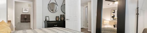 a bedroom with a large bed and a mirror at Ascent Apartments, Cottonwood Heights, 84121