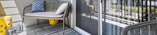 a patio with a chair and a clock on the wall at Ascent Apartments, Cottonwood Heights, UT